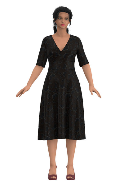 omlott klänning med skärning i midjan, halvlång ärm, klockad kjoldel till under knä med fickor i mörk brunt med svarta fjärilar som har vita prickar från märket Esther & Inez